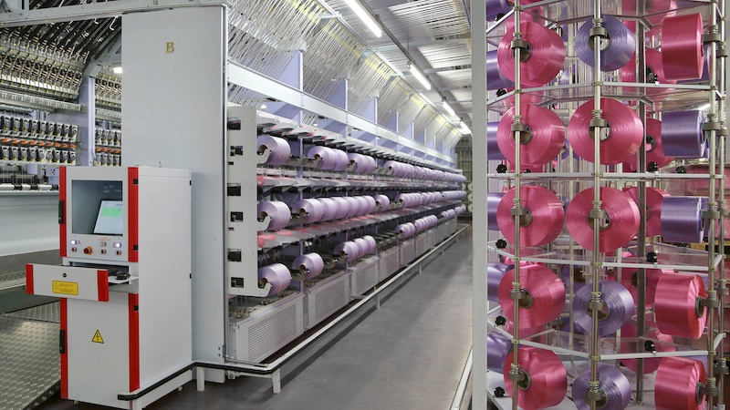 The eAFK Big V multi-spindle texturing machine is a central component of the Oerlikon Barmag product brand for manufacturing high-quality, high-titer yarns © 2025 Barmag