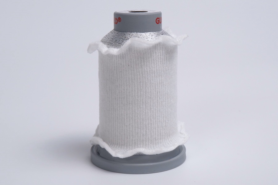 Spool stockings - shown in the convenient dispenser box and placed on a METY Miniking cone. © 2026 Gunold